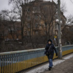 
              A woman walks in a street in Kryvyi Rih, Ukraine, Sunday, Jan. 29, 2023. (AP Photo/Daniel Cole)
            