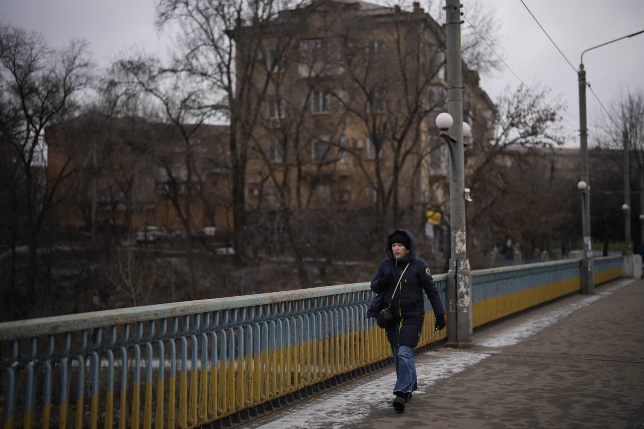 A woman walks in a street in Kryvyi Rih, Ukraine, Sunday, Jan. 29, 2023. (AP Photo/Daniel Cole)...