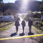 
              FBI officials walk towards the crime scene at Mountain Mushroom Farm, Tuesday, Jan. 24, 2023, after a gunman killed several people at two agricultural businesses in Half Moon Bay, Calif.  Officers arrested a suspect in Monday’s shootings, 67-year-old Chunli Zhao, after they found him in his car in the parking lot of a sheriff’s substation, San Mateo County Sheriff Christina Corpus said.  (AP Photo/Aaron Kehoe)
            