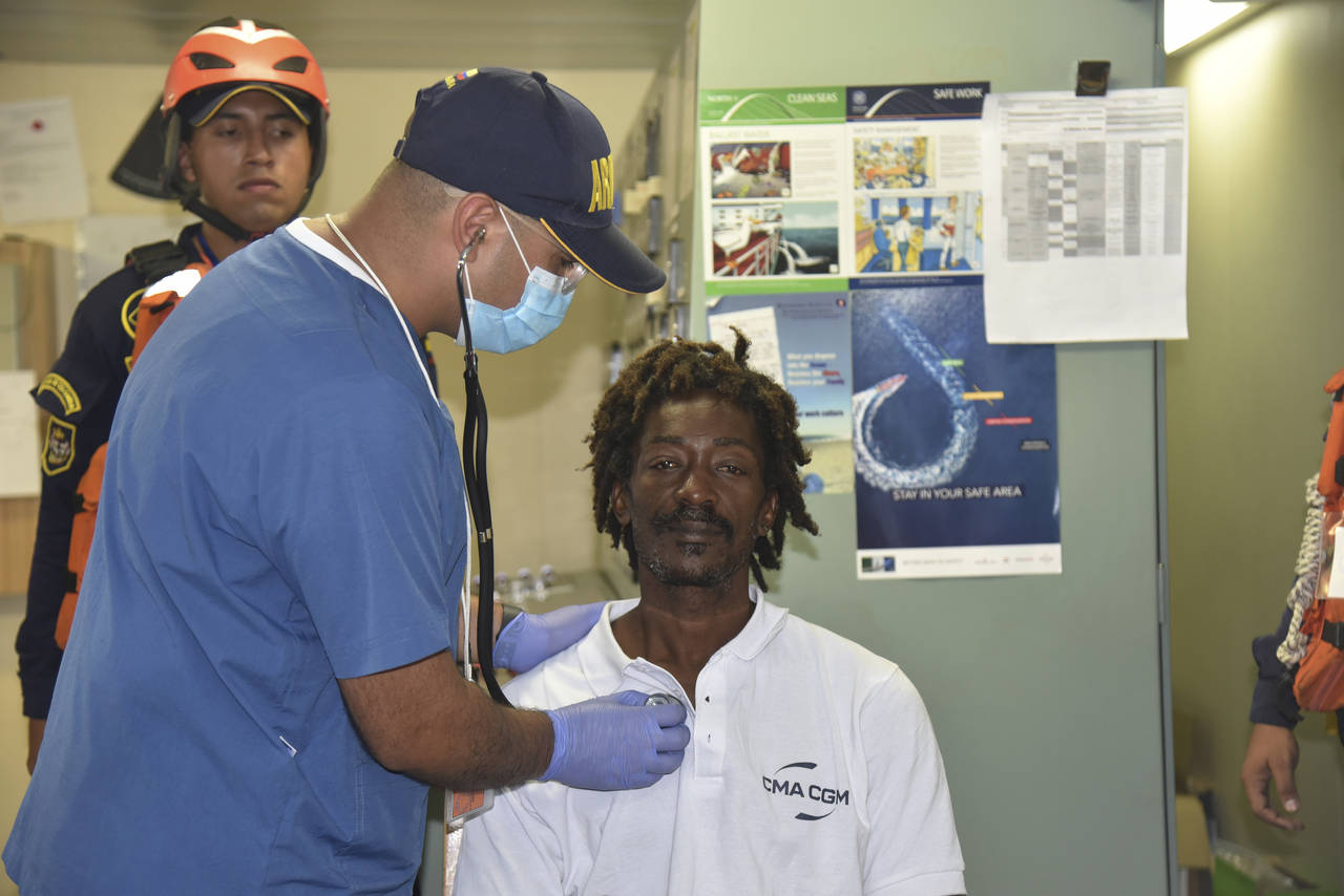 In this photo provided by Colombia's Navy press office, castaway Elvis Francois is attended by Colo...