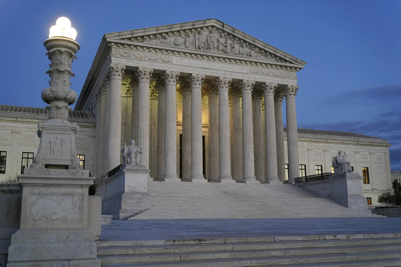 FILE - Light illuminates part of the Supreme Court building at dusk on Capitol Hill in Washington, ...