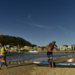 
              People visit La Concha beach on a winter day in San Sebastian, northern Spain, Wednesday, Jan. 4, 2023. (AP Photo/Alvaro Barrientos)
            