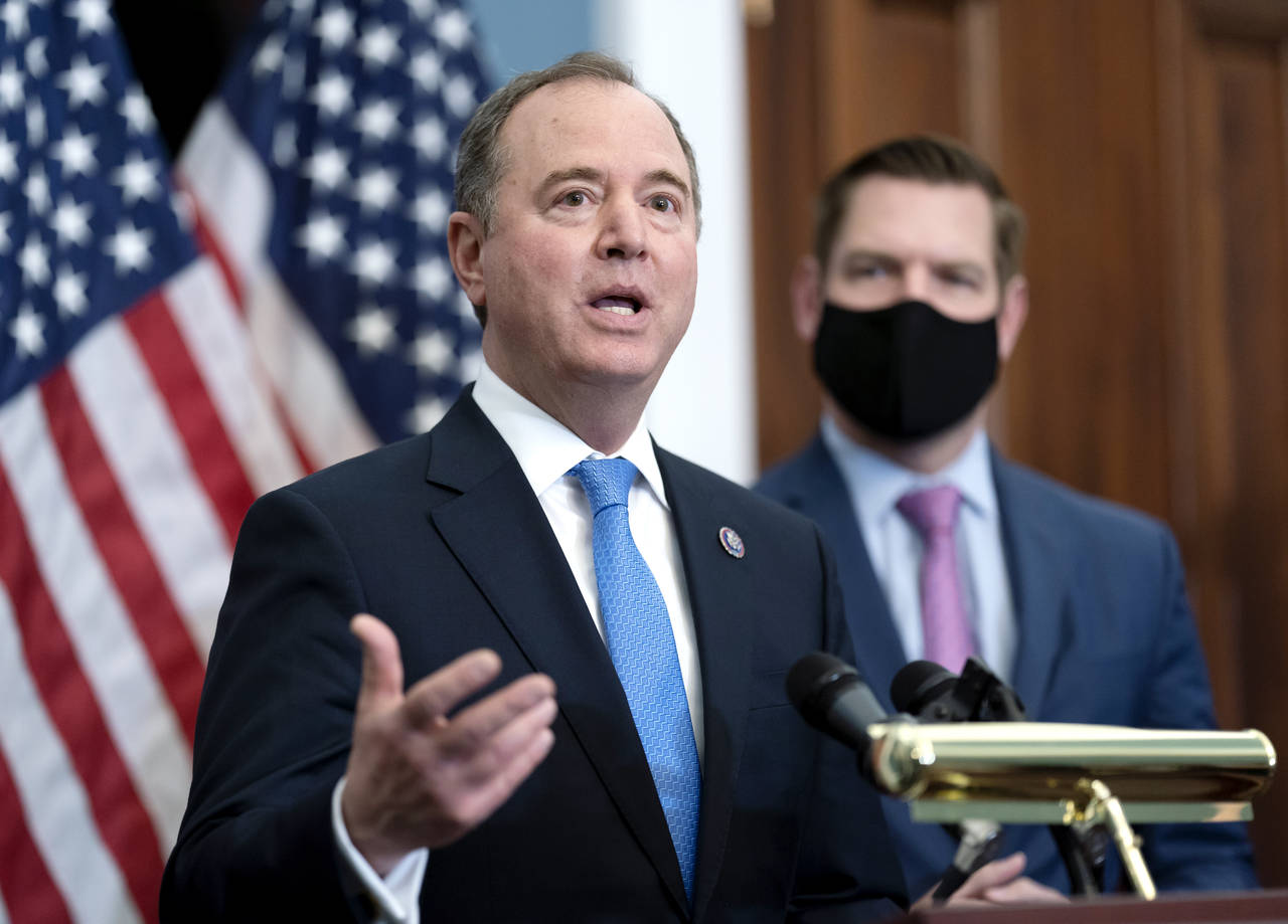 FILE - House Intelligence Committee Chairman Adam Schiff, D-Calif., left, joined by Rep. Eric Swalw...