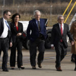 Senate Minority Leader Mitch McConnell of Ky., center, and Ohio Gov. Mike DeWine, second from right, arrive to greet President Joe Biden at Cincinnati/Northern Kentucky International Airport in Hebron, Ky., Wednesday, Jan. 4, 2023. Biden is in Kentucky to promote his infrastructure agenda. (AP Photo/Patrick Semansky)