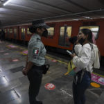 A customer asks for information to a Mexican National Guard officer at a city subway station in Mexico City, Thursday, Jan. 12, 2023. The mayor of Mexico City says that more the 6 thousand National Guard officers will be posted in the city's subway system after a series of accidents that officials say could be due to sabotage. (AP Photo/Fernando Llano)