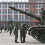 
              Soldiers and tanks are deployed to a preparedness enhancement drill simulating the defense against Beijing's military intrusions, ahead of the Lunar New Year in Kaohsiung City, Taiwan on Wednesday, Jan 11, 2023. China renewed its threats Wednesday to attack Taiwan and warned that foreign politicians who interact with the self-governing island are "playing with fire." (AP Photo/Daniel Ceng)
            