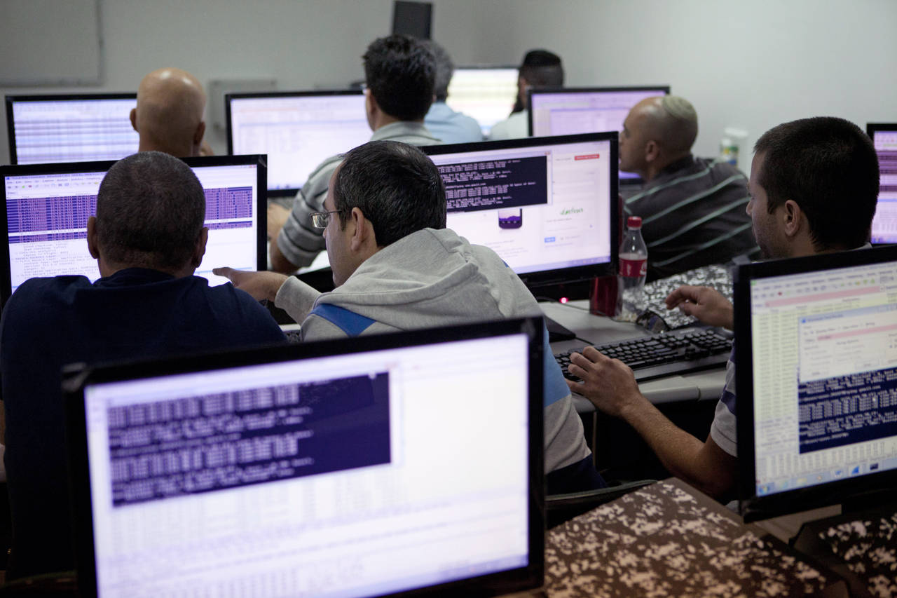 FILE - In this file photo, Israelis work on computers at the 'CyberGym' school in the coastal city ...