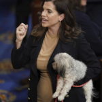 Rep. Nancy Mace, R-S.C., holds her dog after the eleventh vote in the House chamber as the House meets for the third day to elect a speaker and convene the 118th Congress in Washington, Thursday, Jan. 5, 2023. (AP Photo/Alex Brandon)