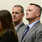 
              Paramedics Peter Cichuniec, center, and Jeremy Cooper, right, listen to attorney Shana Beggan at an arraignment at the Adams County Justice Center in Brighton, Colo., on Friday, Jan. 20, 2023. Aurora Police officers Nathan Woodyard, Randy Roedema and former officer Jason Rosenblatt along with paramedics Jeremy Cooper and Peter Cichuniec were indicted by a Colorado state grand jury in 2021 on 32 combined accounts related to Elijah McClain's arrest and death in August 2019. (Andy Cross/The Denver Post via AP)
            