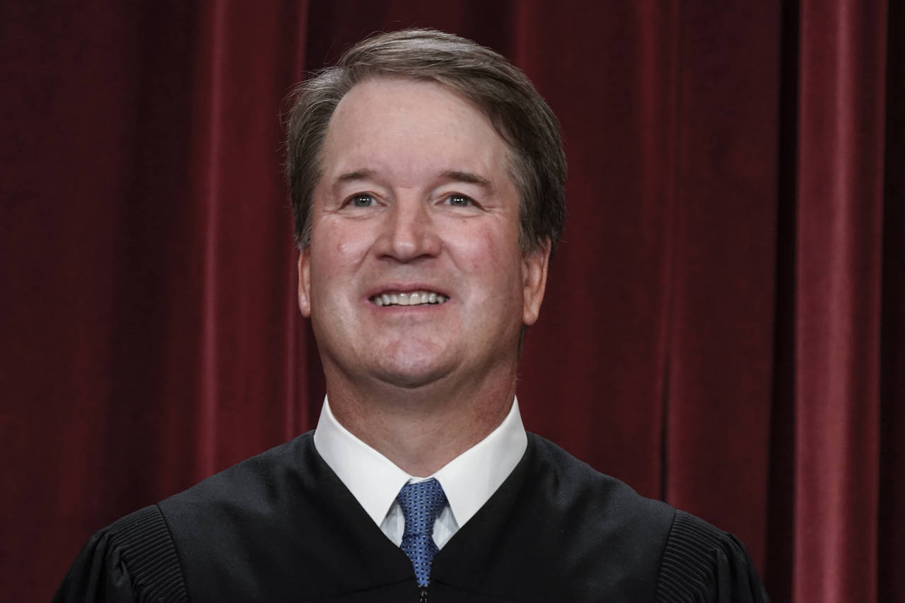 FILE - Associate Justice Brett Kavanaugh joins other members of the U.S. Supreme Court as they pose...