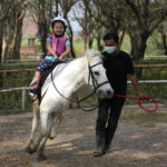 
              Rylae-Ann Poulin learns to ride a horse in Bangkok, Thailand, Saturday, Jan. 14, 2023.(AP Photo/Sakchai Lalit)
            