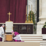 
              Archbishop Georg Ganswein kneels by the coffin of late Pope Emeritus Benedict XVI after it's brought to St. Peter's Square for a funeral mass at the Vatican, Thursday, Jan. 5, 2023. Benedict died at 95 on Dec. 31 in the monastery on the Vatican grounds where he had spent nearly all of his decade in retirement. (AP Photo/Alessandra Tarantino)
            