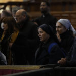 
              Mouners look at the body of late Pope Emeritus Benedict XVI lied out in state inside St. Peter's Basilica at The Vatican, Wednesday, Jan. 4, 2023. Pope Benedict, the German theologian who will be remembered as the first pope in 600 years to resign, has died, the Vatican announced Saturday, Dec. 31, 2022. He was 95.(AP Photo/Ben Curtis)
            