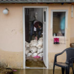 
              A man salvages belongings from a flooded house in Cacak, Serbia, Thursday, Jan. 19, 2023. Heavy rainfall this week across the Balkans has caused rivers to rise dangerously in Serbia, Bosnia and Montenegro, flooding some areas and threatening flood defenses elsewhere, while two people were swept away by a swollen river in the southwestern town of Novi Pazar, according to state RTS television. (AP Photo/Marjan Vucetic)
            