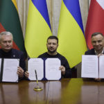 
              In this photo provided by the Ukrainian Presidential Press Office, Ukrainian President Volodymyr Zelenskyy, centre, Polish President Andrzej Duda, right, and Lithuania's President Gitanas Nauseda pose for a photo with signed documents during their meeting in Lviv, Ukraine, Wednesday, Jan. 11, 2023. (Ukrainian Presidential Press Office via AP)
            