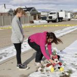 
              Alecia Jones, right, with her daughter Brooklyn, 13, places a Minnie Mouse stuffed animal by police tape near a home where eight members of a family were killed in Enoch, Utah, on Thursday, Jan. 5, 2023. Brooklyn was friends with one of the victims. A Utah man fatally shot his five children, his mother-in-law and his wife, then killed himself two weeks after the woman had filed for divorce, according to authorities and public records. (Laura Seitz/The Deseret News via AP)
            