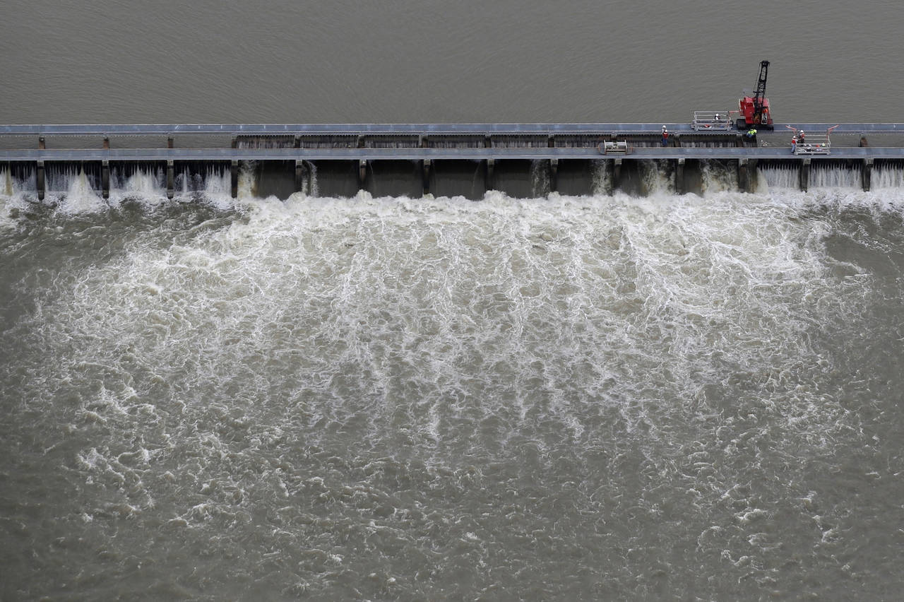 FILE - Workers open bays of the Bonnet Carre Spillway to divert rising water from the Mississippi R...