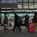 
              Passengers arriving from China pass by a COVID-19 testing center at the Incheon International Airport in Incheon, South Korea, Tuesday, Jan. 10, 2023. China suspended visas Tuesday for South Koreans to come to the country for tourism or business in apparent retaliation for COVID-19 testing requirements on Chinese travelers. (AP Photo/Ahn Young-joon)
            