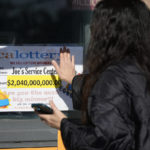 
              People touch a window sign for good luck announcing the $2.04 billion-winning Powerball ticket award at Joe's Service Center, a Mobil gas station at Woodbury Road and Fair Oaks Avenue in Altadena, Calif., Friday, Jan. 6, 2023. Lottery players whose numbers didn't hit or who forgot to even buy a ticket will have another shot at a nearly $1 billion Mega Millions prize. The estimated $940 million jackpot up for grabs Friday night has been growing for more than two months and now ranks as the sixth-largest in U.S history. (AP Photo/Damian Dovarganes)
            