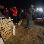 
              Rev. Andre E Johnson, of the Gifts of Life Ministries, preaches at a candlelight vigil for Tyre Nichols, who died after being beaten by Memphis police officers, in Memphis, Tenn., Thursday, Jan. 26, 2023. Behind him, seated at left, is Tyre's stepfather Rodney Wells. (AP Photo/Gerald Herbert)
            