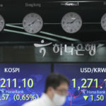 
              A currency trader walks by the screens showing the Korea Composite Stock Price Index (KOSPI), left, and the foreign exchange rate between U.S. dollar and South Korean won at a foreign exchange dealing room in Seoul, South Korea, Tuesday, Jan. 3, 2023. Asian stock markets were mixed Tuesday ahead of updates on U.S. employment amid fears of a possible global recession. (AP Photo/Lee Jin-man)
            