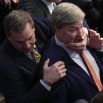 
              Rep. Richard Hudson, R-N.C., left, pulls Rep. Mike Rogers, R-Ala., back as they talk with Rep. Matt Gaetz, R-Fla., and other during the 14th round of voting for speaker as the House meets for the fourth day to try and elect a speaker and convene the 118th Congress in Washington, Friday, Jan. 6, 2023. (AP Photo/Andrew Harnik)
            