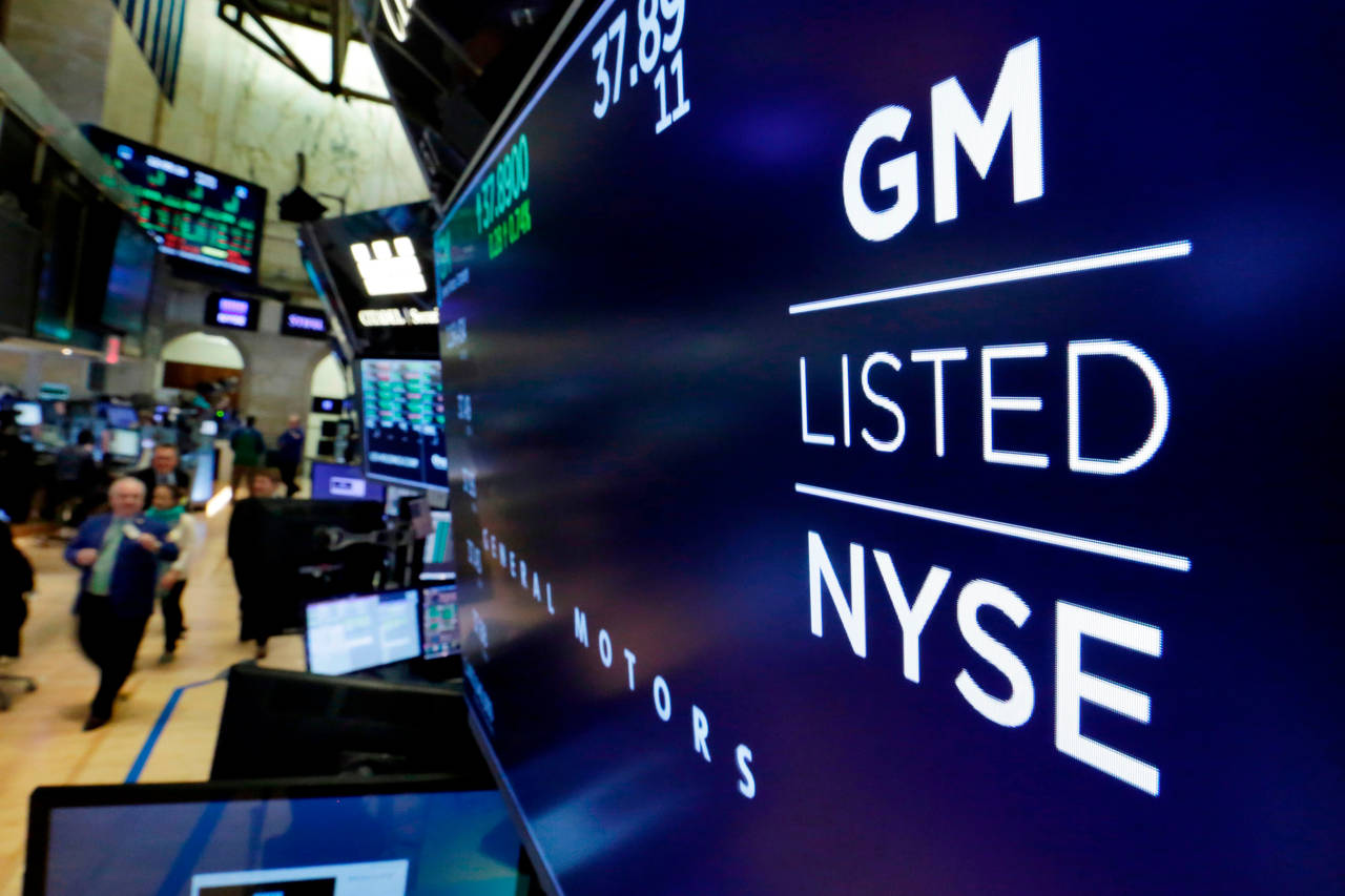 FILE - In this April 23, 2018, file photo, the logo for General Motors appears above a trading post...