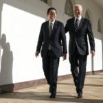 
              President Joe Biden walks with Japanese Prime Minister Fumio Kishida to a meeting in the Oval Office of the White House, Friday, Jan. 13, 2023, in Washington. (AP Photo/Evan Vucci)
            