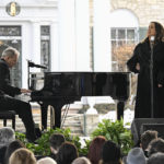 
              Alanis Morissette, right, and Mike Farrell perform during a memorial service for Lisa Marie Presley Sunday, Jan. 22, 2023, in Memphis, Tenn. She died Jan. 12 after being hospitalized for a medical emergency and was buried on the property next to her son Benjamin Keough, and near her father Elvis Presley and his two parents. (AP Photo/John Amis)
            