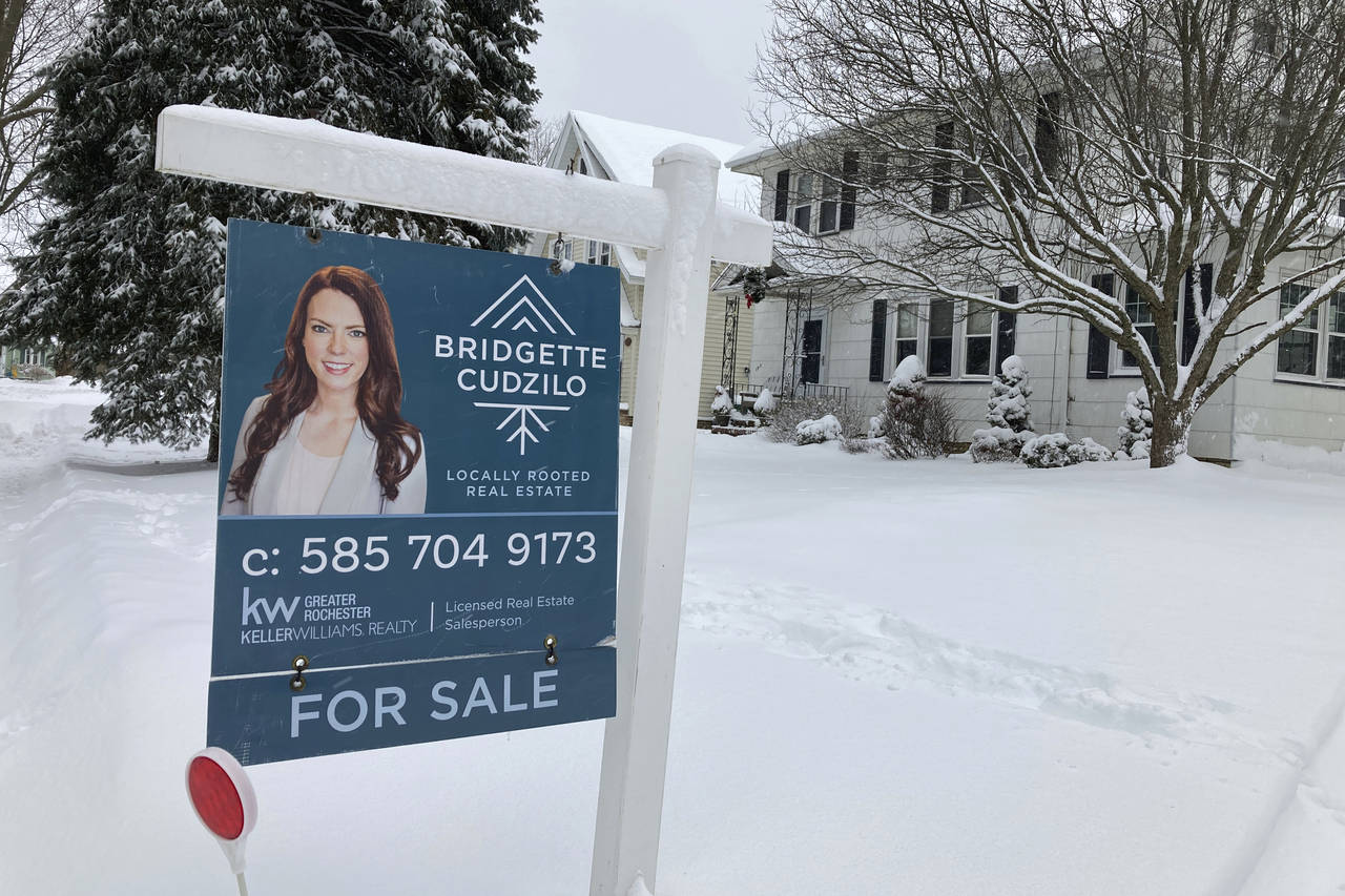 File - A "For Sale" sign stands in front of a house in Rochester, New York, on Monday, January 17, ...