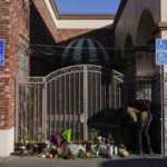 
              A videographer records flowers and candles placed outside Star Dance Studio in Monterey Park, Calif., Monday, Jan. 23, 2023. Authorities searched for a motive for the gunman who killed multiple people at the ballroom dance club during Lunar New Year celebrations, slayings that sent a wave of fear through Asian American communities and cast a shadow over festivities nationwide. (AP Photo/Jae C. Hong)
            