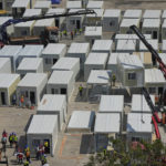 
              FILE - An aerial view shows a construction site of a new makeshift COVID-19 hospital and isolation facilities in Tsing Yi of Hong Kong, on Feb. 26, 2022. Hong Kong will scrap its mandatory isolation rule for people infected with COVID-19 from Jan. 30 as part of its strategy to return the southern Chinese city to normalcy, the city's leader said on Thursday, Jan. 19, 2023.(AP Photo/Kin Cheung, File)
            