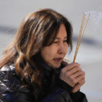 
              A woman is emotional as she holds incense near a memorial outside the Star Ballroom Dance Studio on Tuesday, Jan. 24, 2023, in Monterey Park, Calif. A gunman killed multiple people at the ballroom dance studio late Saturday amid Lunar New Years celebrations in the predominantly Asian American community. (AP Photo/Ashley Landis)
            