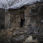 
              Oleksandra Hryhoryna inspects her house which was damaged by shelling last fall in Kalynivske, Ukraine, Saturday, Jan. 28, 2023. (AP Photo/Daniel Cole)
            