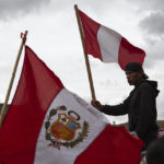 
              A person waves a Peruvian flag while waiting for other union groups to arrive at Plaza de Armas to join anti-government protests in Cusco, Peru, Thursday, Jan. 19, 2023. Protesters are seeking immediate elections, President Dina Boluarte's resignation, the release of ousted President Pedro Castillo and justice for up to 48 protesters killed in clashes with police.   (AP Photo/Manuel Orbegozo)
            
