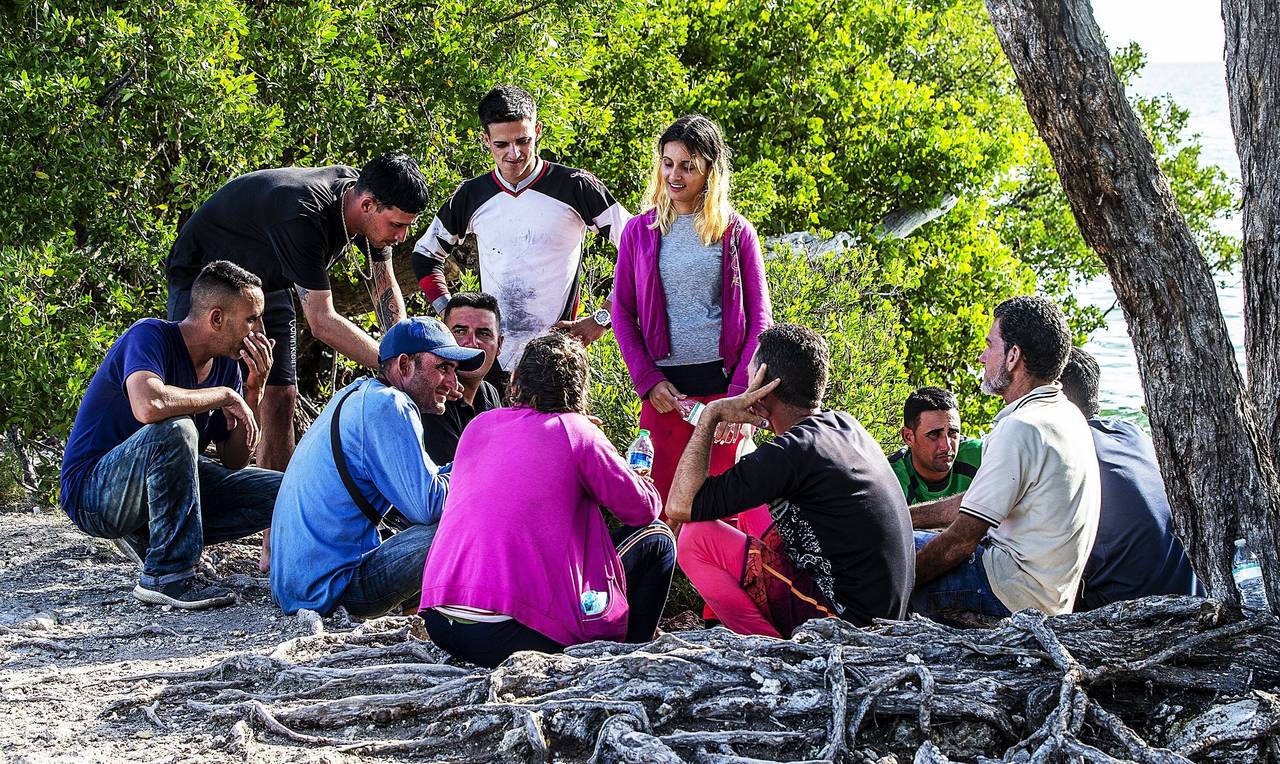 A group of Cuban migrants gather on the side of U.S. 1 in the Middle Keys island of Duck Key, Fla.,...