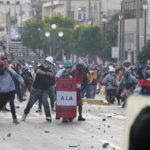 
              Anti-government protesters face off with the police in Lima, Peru, Tuesday, Jan. 24, 2023. Protesters are seeking the resignation of President Dina Boluarte, the release from prison of ousted President Pedro Castillo, immediate elections and justice for demonstrators killed in clashes with police. (AP Photo/Martin Mejia)
            