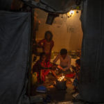 
              A homeless family sit around a bonfire inside a dilapidated shelter for homeless people on a cold night in New Delhi, India, Dec. 28, 2022. Even though the city’s night shelters are a refuge to many who would otherwise find themselves sleeping near traffic-busy roundabouts and underpasses, most people there live in harsh conditions. (AP Photo/Altaf Qadri)
            