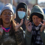 
              Venezuelan migrants pray at the camping site outside the Sacred Heart Church in downtown El Paso, Texas, Sunday, Jan. 8, 2023. President Joe Biden arrived in Texas on Sunday for his first trip to the U.S.-Mexico border since taking office, stopping in El Paso after two years of hounding by Republicans who have hammered him as soft on border security while the number of migrants crossing spirals. (AP Photo/Andres Leighton)
            