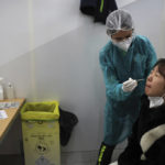 
              A passenger arriving from China is tested for COVID-19 at the Roissy Charles de Gaulle airport, north of Paris, Sunday, Jan. 1, 2023. France says it will require negative COVID-19 tests of all passengers arriving from China and is urging French citizens to avoid nonessential travel to China. (AP Photo/Aurelien Morissard)
            