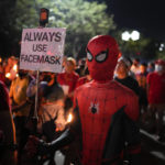 
              A man dressed in a Spiderman costume joins the "Walk of Faith" procession as part of celebrations for the feast day of the Black Nazarene, a centuries-old charred statue of Jesus Christ, on Sunday, Jan. 8, 2023, in Manila, Philippines. The annual Black Nazarene feast day which will be held on Jan. 9 draws massive numbers of devotees who pray for the sick and a better life in this predominantly Roman Catholic nation. (AP Photo/Aaron Favila)
            