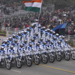 
              An Indian army daredevil team displays their skill on motorcycles as they drive through the ceremonial Kartavya Path boulevard during India's Republic Day celebrations in New Delhi, India, Thursday, Jan. 26, 2023. Tens of thousands of people shed COVID-19 masks but faced morning winter chill and mist at a ceremonial parade in the Indian capital on Thursday showcasing India's defence capability and cultural and social heritage on a long revamped marching ceremonial boulevard from the British colonial rule.(AP Photo/Manish Swarup)
            