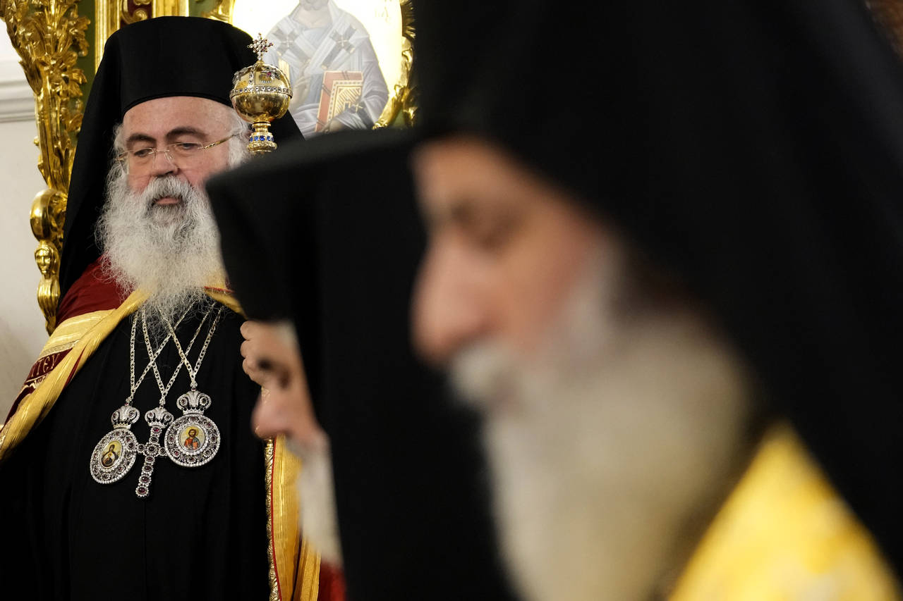 The head of Cyprus' Orthodox Church Archbishop Georgios, left, looks on during his enthronement cer...