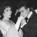 
              FILE - German actor Horst Buchholz kisses the hand of Italian actress Gina Lollobrigida, during the International Film Festival (Berlinale) in Berlin, Germany, July 5, 1958. (AP Photo/Werner Kreusch, File) Lollobrigida has died in Rome at age 95. Italian news agency Lapresse reported Lollobrigida’s death on Monday, Jan. 16, 2023 quoting Tuscany Gov. Eugenio Giani. (AP Photo/Werner Kreusch, File)
            