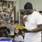 
              In this image provided by the Des Moines Public Schools, community activist and rap artist Will Keeps works with students at Harding Middle School on Sept. 27, 2017, in Des Moines, Iowa. Students watched his latest music video, 'Droppin' and analyzed his lyrics as part of their literacy class. Keeps is hospitalized in serious condition after surgery following just the sort of violence he's devoted his life to stop -- a shooting that killed two teenagers at the Starts Right Here educational program he founded in Des Moines. Keeps was hurt Monday, Jan. 23, 2023, when he tried to intervene. (Jon Lemons/Des Moines Public Schools via AP)
            