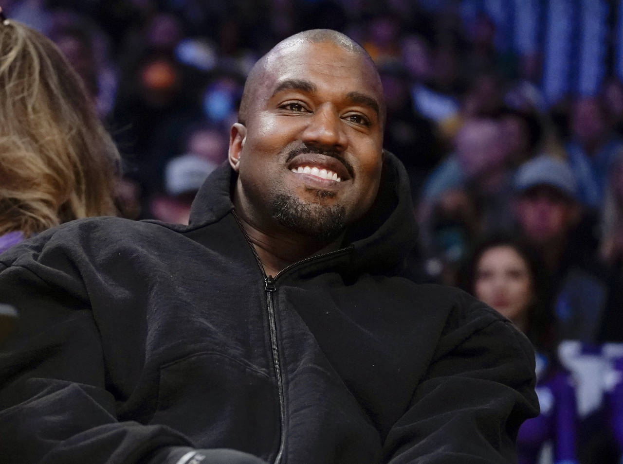 FILE - Kanye West, known as Ye, watches the first half of an NBA basketball game between the Washin...