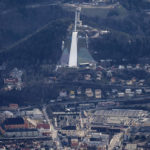 
              The 'Bergisl' ski-jumping hills in Innsbruck, Austria, Monday, Jan. 2, 2023. Sparse snowfall and unseasonably warm weather in much of Europe is allowing green grass to blanket many mountaintops across the region where snow might normally be. It has caused headaches for ski slope operators and aficionados of Alpine white this time of year. (AP Photo/Matthias Schrader)
            