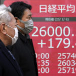 
              People walk in front of an electronic stock board showing Japan's Nikkei 225 index at a securities firm Friday, Jan. 6, 2023, in Tokyo. Asian shares were mostly higher Friday after Wall Street benchmarks fell on worries that the U.S. Federal Reserve will keep raising interest rates. (AP Photo/Eugene Hoshiko)
            