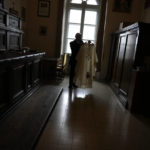 
              Father Tadeusz Rozmus shows a cassock belonging to the late Pope Emeritus Benedict XVI during an interview with the Associated Press in the San Tommaso Da Villanova Parrish church in Castel Gandolfo, in the hills south of Rome, Tuesday Jan. 3, 2023. Benedict's death has hit Castel Gandolfo's "castellani" particularly hard, since many knew him personally, and in some ways had already bid him an emotional farewell on Feb. 28, 2013, when he uttered his final words as pope from the palace balcony overlooking the town square. (AP Photo/Alessandra Tarantino)
            