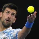 
              Novak Djokovic of Serbia serves to Andrey Rublev of Russia during their quarterfinal match at the Australian Open tennis championship in Melbourne, Australia, Wednesday, Jan. 25, 2023. (AP Photo/Ng Han Guan)
            